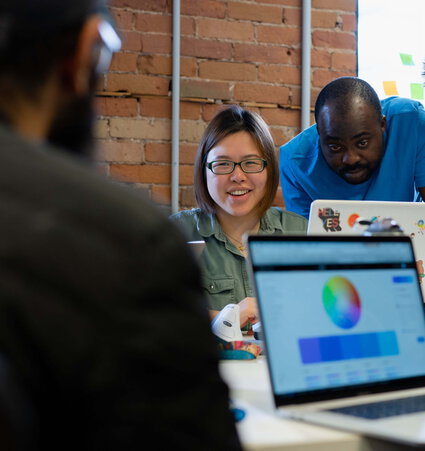 people looking at laptop