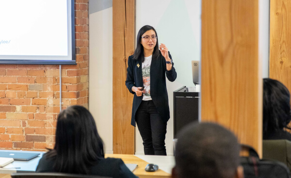 Woman speaking in front of classroom